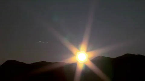 Sun rises behind the mountains time lapse Stock Footage
