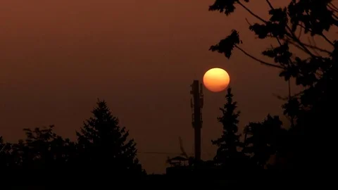The sun rises behind a pipe Stock Footage 70870950