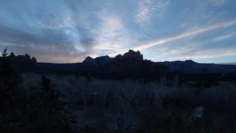 The sun rises behind the rock formation Merry-Go-Round in Sedona, AZ Stock Footage 87444505