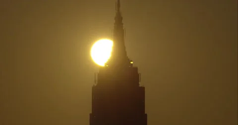 The sun rises behind the silhouetted Empire State Building in New York City. Stock Footage 67241613