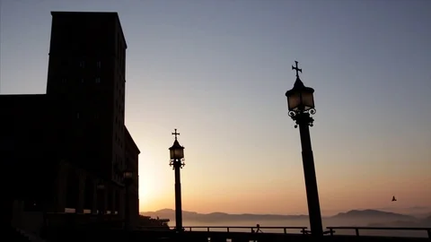 The sun rises behind the silhouetted monastery of Montserrat Stock Footage 77069777