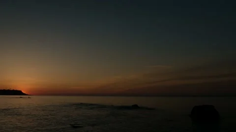 The sun rises from the cape on the background of a calm sea. Dawn. Stock Footage 66295881