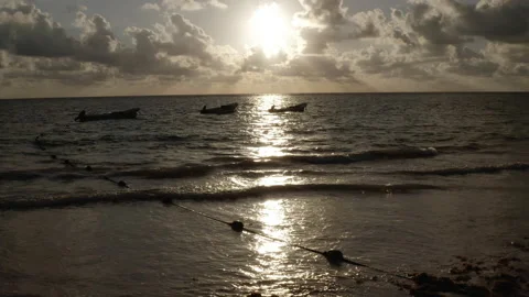 Sun rises as fishing boats float near shoreline as seen from above Stock Footage 138656587