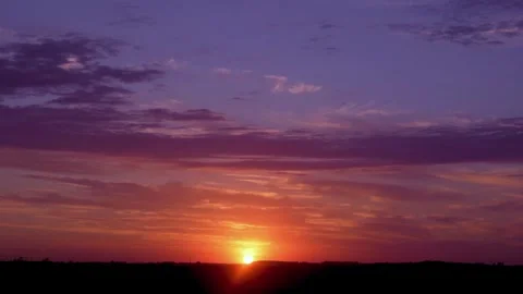 Sun Rises from the Horizon in a Field in an Incredibly Beautiful Sky with Time L Stock Footage 242599811