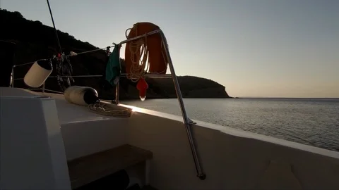 The sun rises on a lonely bay view from a sailboat Stock Footage 95835715