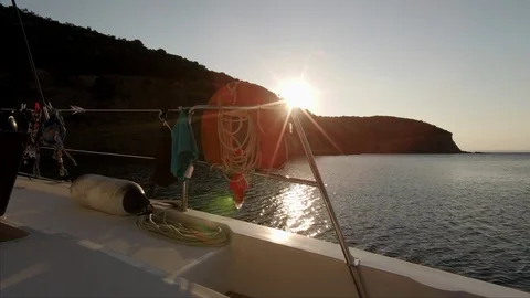 The sun rises on a lonely bay view from a sailboat Stock Footage 95835792