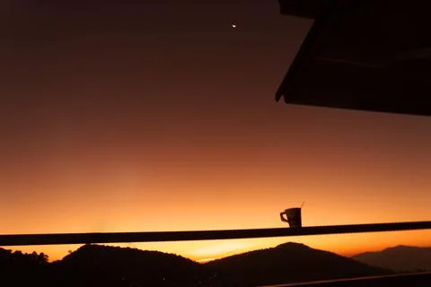 The sun rises Orange light behind a big mountain Stock Photos