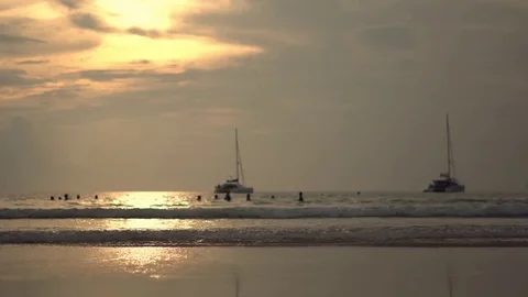 The sun rises over a beautiful beach in Thailand as waves wash across the sand Video stock 73539766