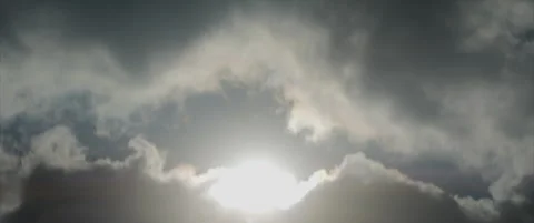 Sun rises over the clouds anamorphic 4K footage Stock Footage 318729572