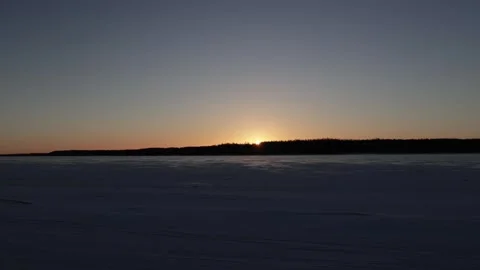 Sun rises over forest and frozen river. Beautiful winter landscape Stock Footage 299710693