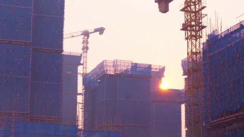 The sun rises over the high-rise building under construction in the morning Stock Footage 327629189