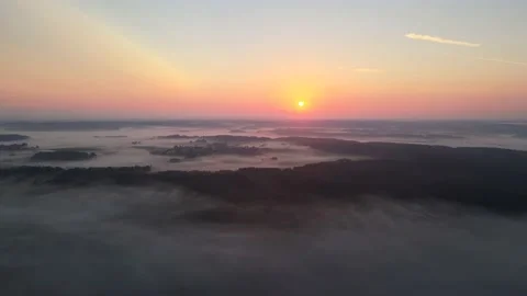 Sun rises over low mist Stock Footage 164597263