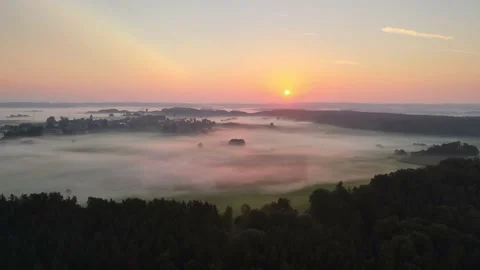 Sun rises over low mist Stock Footage 164597344