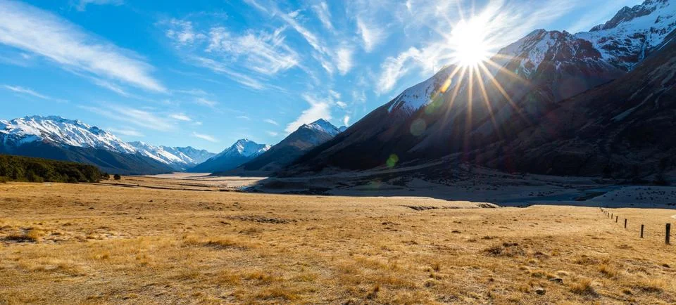 The Sun Rises Over a Mountain Range Stock Photos