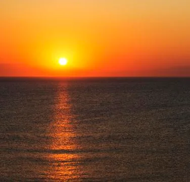 The sun rises over mountains in Turkey seen from Rhodes Stock Photos