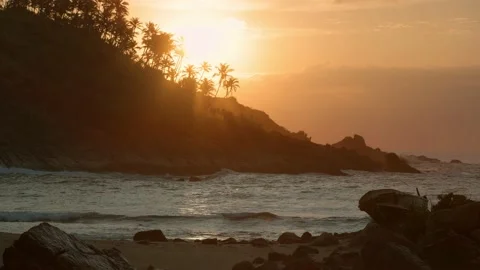 The sun rises over the ocean. Sunrise on a wild beach in Sri Lanka. Mirissa.. Stock Footage 228293500