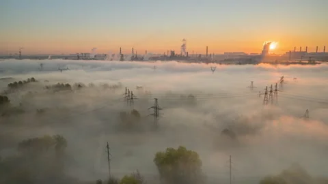 The sun rises over a river valley filled with fog Stock Footage 164947210