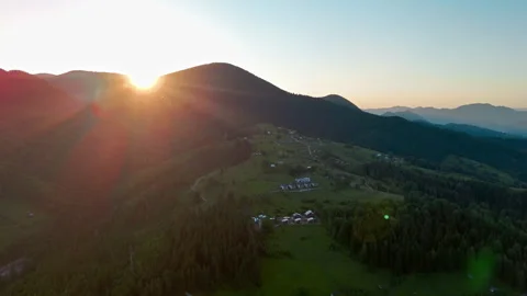 Sun rises over a rounded mountain peak and a shadowed rural valley, Scenic 库存影片 344866231