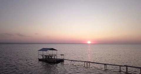 The sun rises over the sea, flying over the pier Stock Footage 117912253