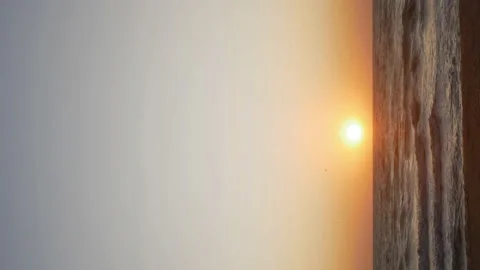 The sun rises over the sea or ocean at dawn on a vertical screen Stock Footage 114910986