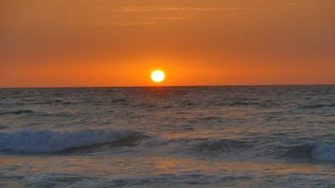 The sun rises over the sea Stock Photos