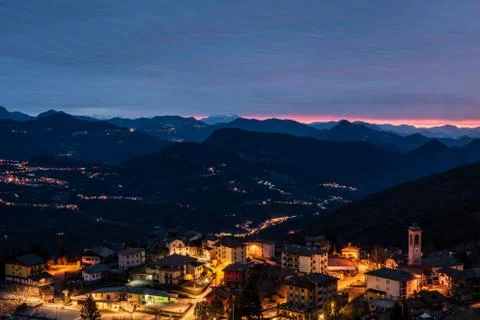 The sun rises over a small mountain village Stock Photos