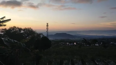 The sun rises over small private houses in the mountains Stock Footage 272190471