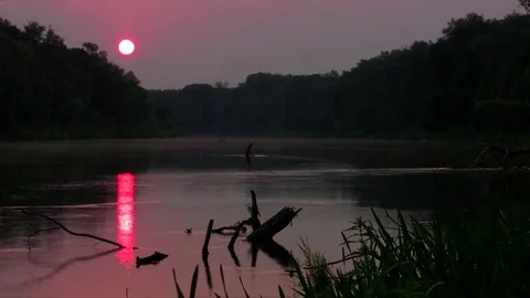 The sun rises over the Wild River Stock Footage 84380015