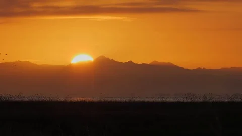 Sun rising behind Coromandel ranges in New Zealand Stock Footage 104083804