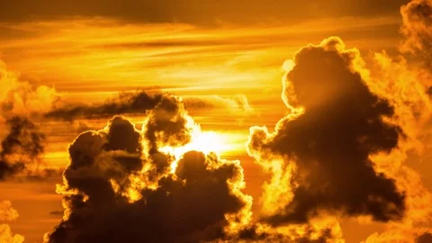 Sun rising behind dramatic tropical clouds. 4K UHD timelapse Stock Footage 71813426