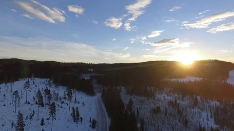 The sun rising behind the forest on a sunny winter day Stock Footage 99118201