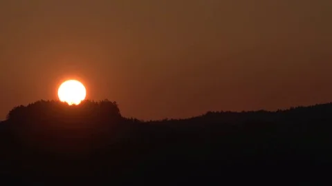 Sun rising behind the mountains at dawn Stock Footage 75993328