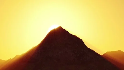 The sun rising from behind the mountains Stock Footage