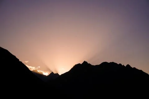 Sun rising behind the mountains. Gilgit-Baltistan, Pakistan. Stock Photos
