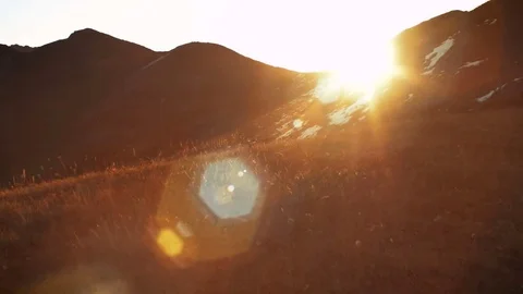 Sun rising from behind snow mountains. Tight shot with a beautiful lens flare Vídeos de archivo 71208129