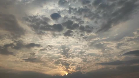 SUN RISING FROM BETWEEN THE CLOUDS Video stock 238878275