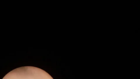 Sun rising in black sky Stock Footage 84728433