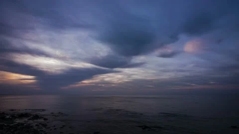 The sun is rising in the clouds of the beach. time lapse. 動画素材 145889674