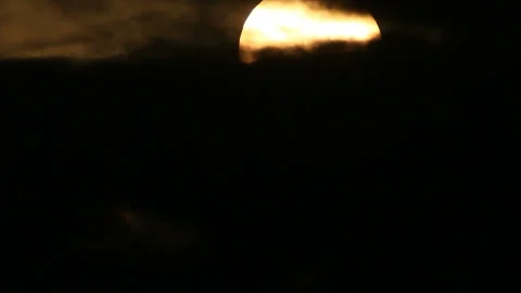 Sun rising from dark cloudscape Stock Footage 133269645