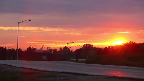 Sun rising on an empty road in an industrial park Stock Footage 80440392