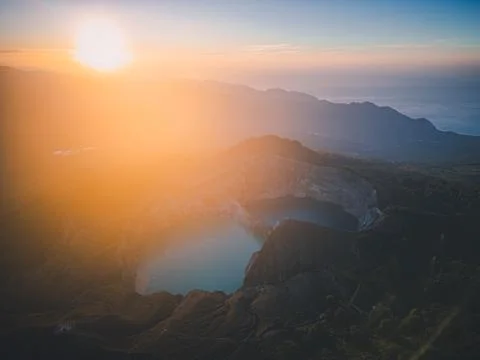 The sun rising at Kelimutu. It is an active volcano near Moni in central Flor Stock Photos