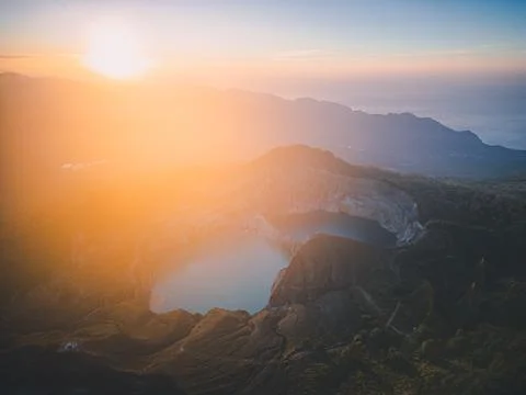The sun rising at Kelimutu. It is an active volcano near Moni in central Flor Stock Photos