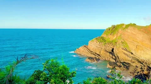 Sun rising from the ocean viewed from the peak of majestic Mong Rong stone Stock Footage 325093348