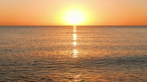 Sun Rising Over the Calm Sea Stock Footage 75065405