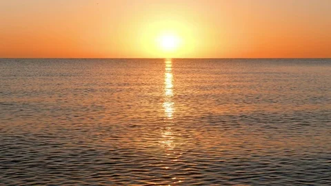 Sun Rising Over the Calm Sea Stock Footage 75065618