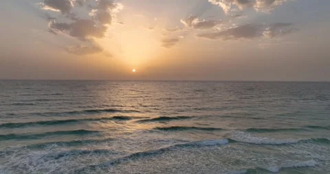 Sun rising over clear blue seas Stock Footage 343622076