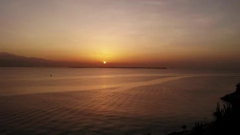Sun rising over island Stock Footage