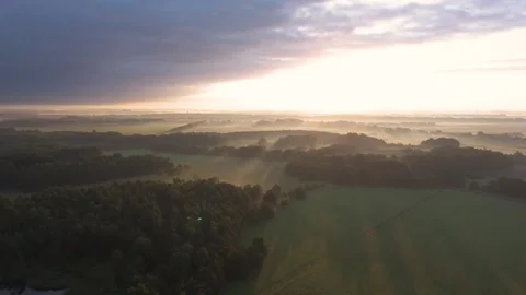 Sun rising over misty forest and countryside Stock Footage 288590860