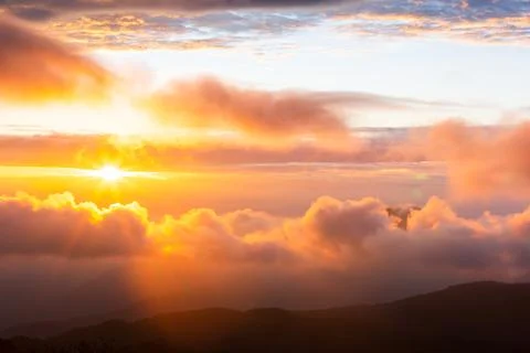 The sun rising over the mountain range. Stock Photos