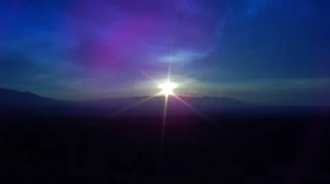 Sun Rising Over Mountain Ridge Zoom In Stock Footage